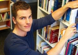 Librarian working in the book shelves