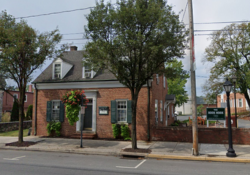 The Book Nook - a brick house building facing the tree-lined King Street in Shippensburg PA