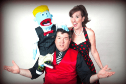 Image of two comedy performers with a puppet