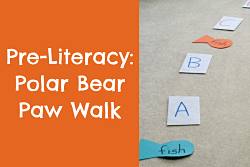 Pre-literacy game on carpeted floor using fish and alphabet letters