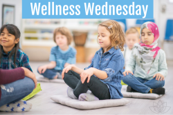 Several children sit on the floor meditating with their eyes clothes