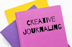"Creative Journaling" text with image of colorful journals