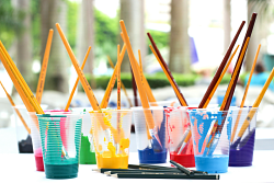 paint in jars with brushes