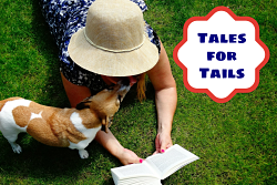 woman on grass reading to dog